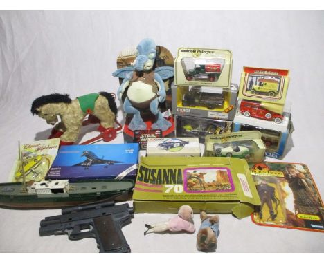 A collection of various toys including a small selection of  boxed die-cast vehicles, toy guns, small pull-along horse, model