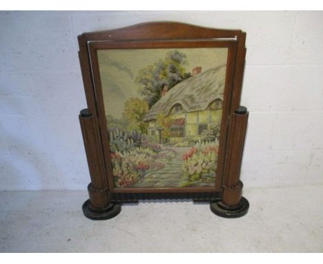 An Art Deco fire screen with tapestry inset  