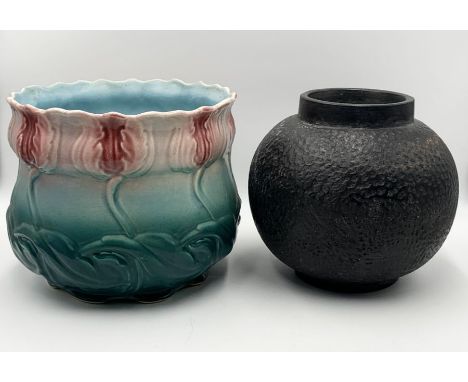 A ceramic jardinière of flower design along with a heavy black pottery vase