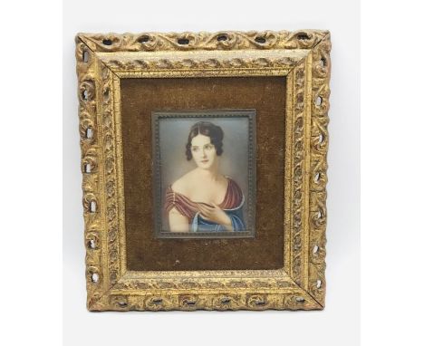 A portrait miniature of a girl in ornate gilt frame