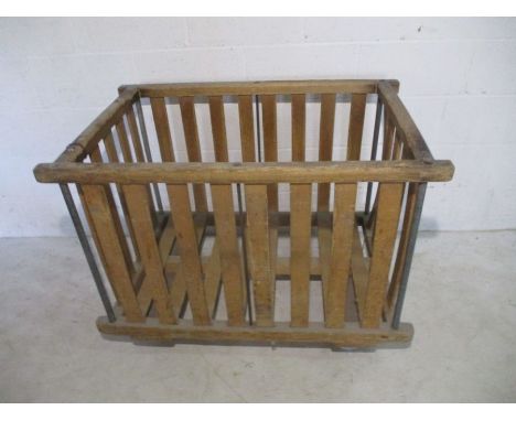 An industrial slatted wooden bobbin trolley