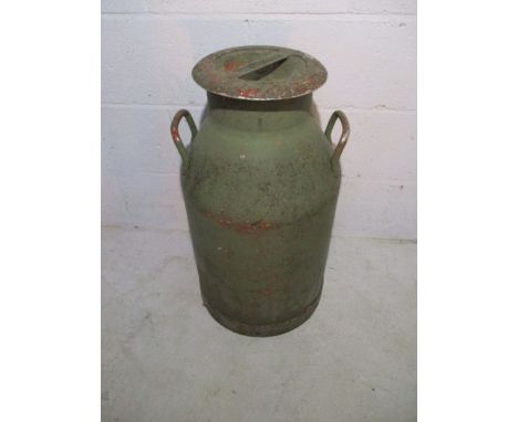 A vintage green painted milk churn