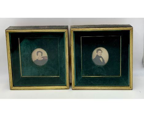 A pair of oval portrait miniatures framed in velvet