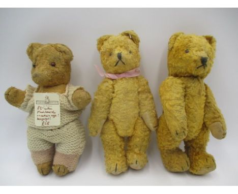 A collection of three plush jointed vintage teddy bears with glass eyes and stitched noses