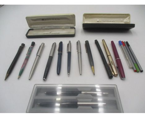 A collection of vintage pens, including Parker.
