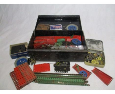 A collection of vintage Meccano in a black storage tin