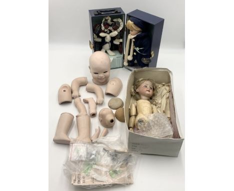 A collection of china dolls both complete and in pieces including an Armand Marseille doll dated 1894 in need of repair. 