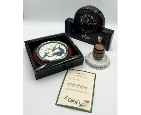 A small collection of Guinness memorabilia including ceramic match striker and clock along with another limited edition boxed