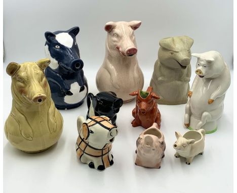 A collection of pig formed jugs including a Sarreguemines majolica ceramic jug along with a number of others 