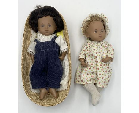 Two unboxed Sasha baby dolls one dark hair in Moses basket and the other blonde in nightdress both in original clothing