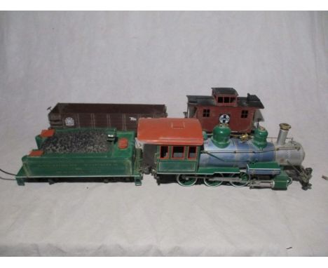 An unboxed Bachmann American 'Big Hauler' Santa Fe R/C receiver locomotive with tender, along with two wagons