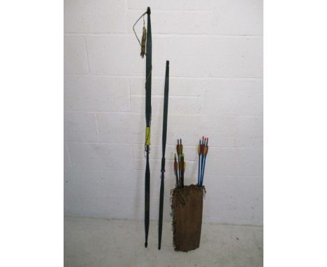 Two vintage Bear North American archery flatbows, along with two sets of arrows