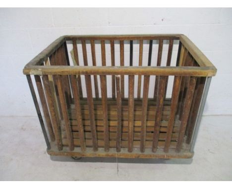 An industrial slatted wooden bobbin trolley