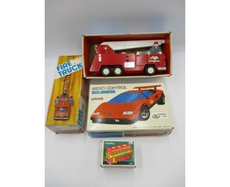 A vintage boxed tin plate Fire Truck with friction siren (MF718), along with a radio controlled Racer Lamborghini, Buddy L Ho