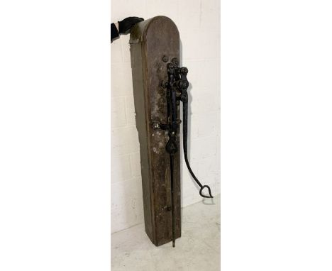 A large vintage water pump mounted on a wooden plinth. Height 162cm, Width 25cm and Depth 27cm