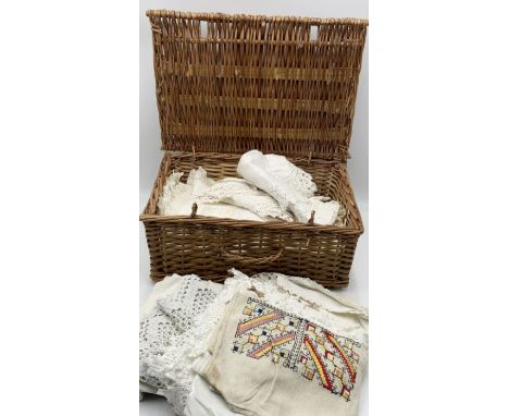 A wicker hamper of vintage table linen 