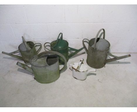 A collection of five vintage galvanised watering cans