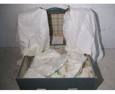 A small collection of vintage linen in a suitcase