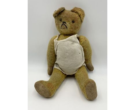 A vintage jointed mohair teddy bear with glass eyes, canvas paws, growler not working