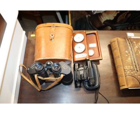 A pair of binoculars; a clock barometer; and a pair of 10 x 25 binoculars in fitted case