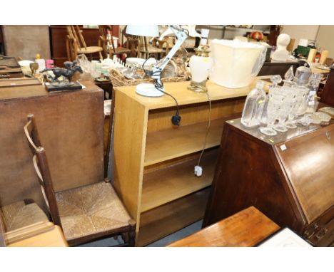 A light wood open fronted bookcase