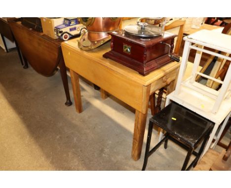 A light wood drop leaf table fitted single end drawer