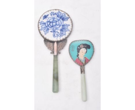 Two Chinese Oriental mid 20th Century handheld vanity mirrors, each with jade handle, white metal edge and one with enamelled