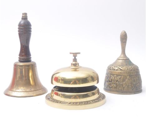 A 19th century brass sanctuary bell, used in churches and places of worship, along with two Bell's scotch whisky advertisemen