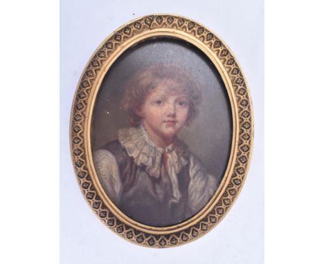 A late 19th Century Victorian oil on board portrait depicting a young boy. The painting oval in shape and in a Renaissance st