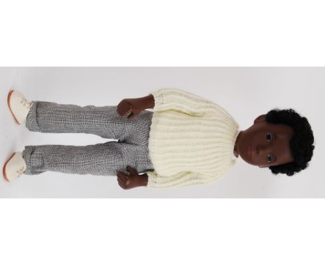 SASHA DOLL: An original vintage 1960's Sasha Doll. Yellow knitted jumper, trousers and short curly black hair. Complete with 