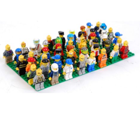 LEGO: A collection of 50x assorted Lego minifigures to include: vintage, Space, Racing, Knights, etc. All mounted on a Lego b
