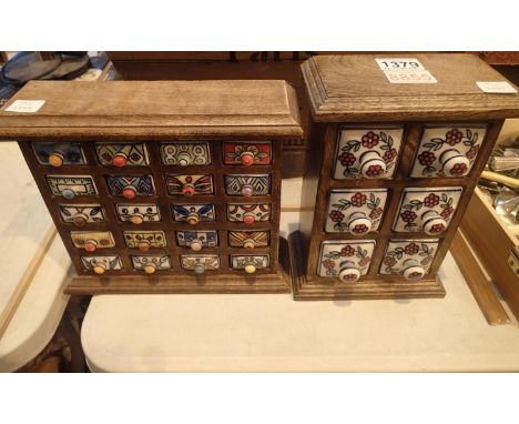 Two modern country kitchen spice cabinets, having twenty ceramic drawers, 26 x 8 x 23 cm H and eight cermic drawers, 18 x 11 