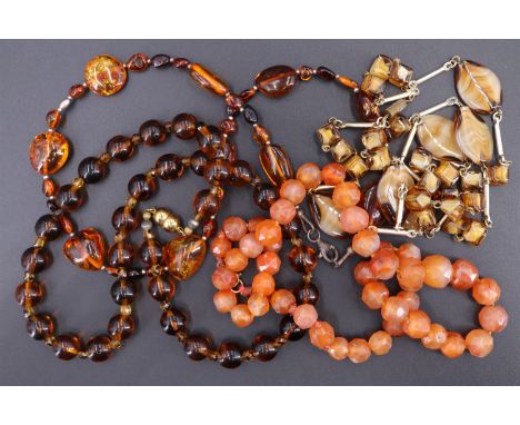 A vintage amber necklace, comprising baroque beads of alternating sizes, together with three costume necklaces, amber necklac