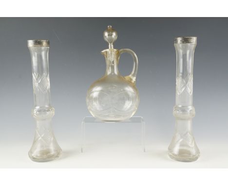 A pair of Edwardian silver mounted cut glass vases, being of tall slender form with bulbous centres, the mounts London, 1905,