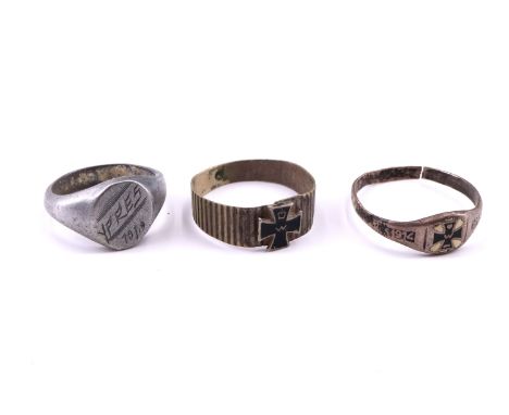 An Imperial German patriotic enamelled white metal finger ring faced with an Iron Cross device and years 1914-1916, a similar