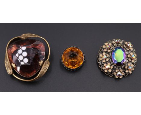 An early 20th century silver and paste brooch, having a 2 cm brilliant, bezel-set and surrounded by a rope twist border, toge