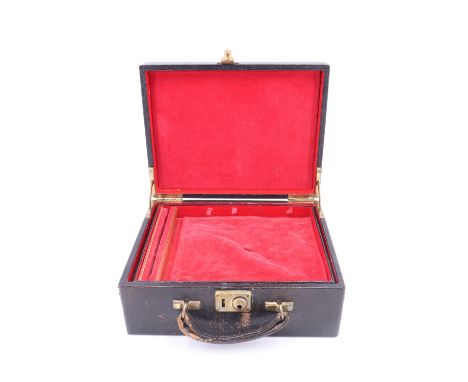 A vintage leather covered jewellery case, having a lift out tray with a ring holder, the cover bearing gilt embossed initials