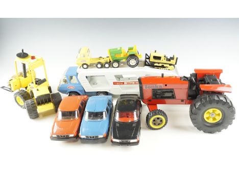 A group of Tonka diecast vehicles, including a tractor, forklift, etc, together with three composition SAAB promotional toy c