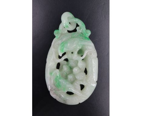 A Chinese carved jade pendant in the form of birds on a bough, 6.5 cm