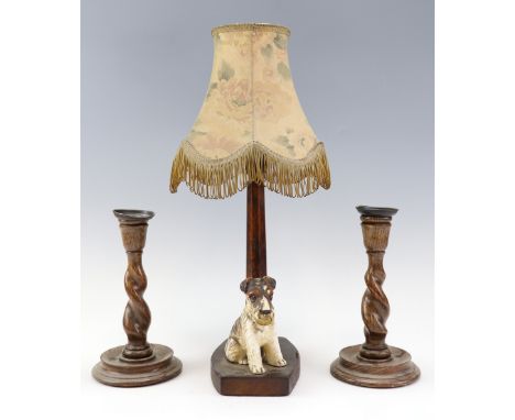 A 1930s West Highland terrier figural table lamp, patinated walnut, together with a pair of oak twist-turned candlesticks, 
