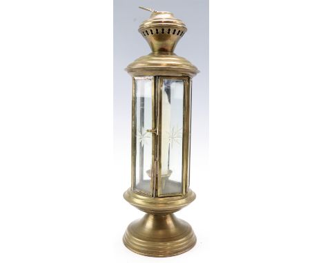 An ornamental brass storm lantern having six star cut glass panels, 34.5 cm excluding handle 