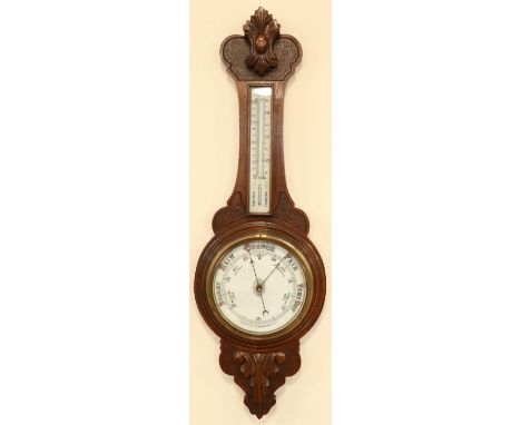 An early 20th Century Comitti of London carved oak banjo aneroid barometer, 88 cm