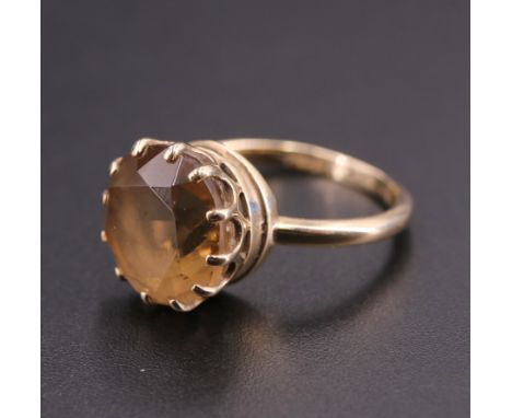 A vintage citrine cocktail ring, the 12 mm stone claw-set on a 9 ct yellow metal shank, N, 3.6 g