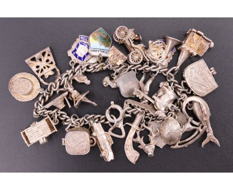 A vintage white metal charm bracelet, (stamped and tested as silver), 71 g