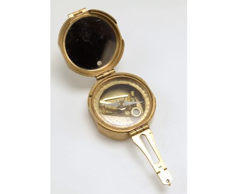 A reproduction brass magnetic compass
