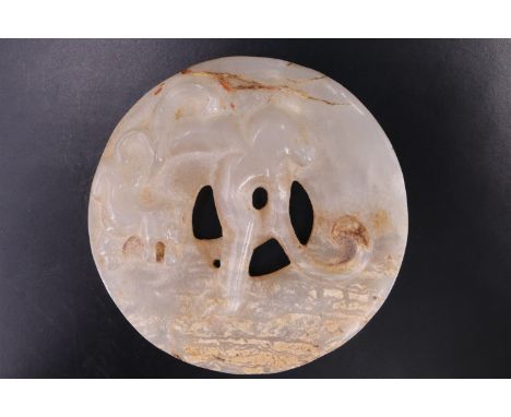 A Chinese carved jade ornament in the form of a beast on an annulus, 57 mm