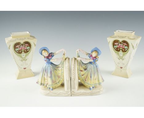 A pair of 1920s figural ceramic book ends, modelled as a girl lifting her hem, marked '37144' to the base, and a pair of flor