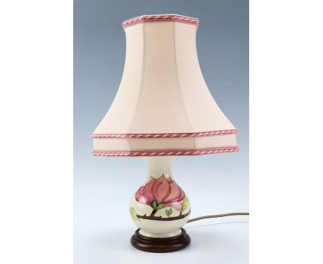 A Moorcroft "Magnolia" pattern table lamp, 24 cm excluding shade