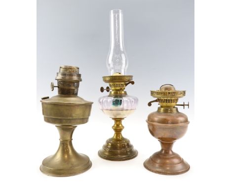 A brass oil lamp, having an amethyst glass reservoir, together with a "Super Aladdin" oil lamp and one other lamp, former 51.