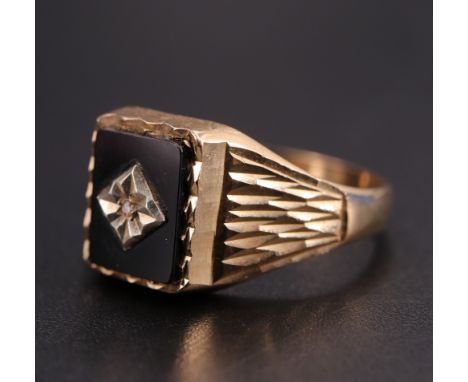 A vintage 9 ct gold signet ring having a black onyx matrix set with a small diamond, R/S, 2.9 g